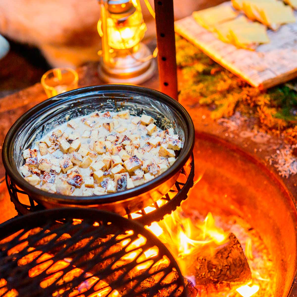 Food is prepared on a campfire.