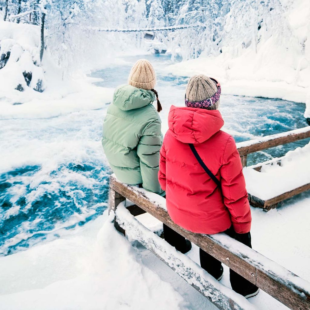 People are watching a foaming winter river.